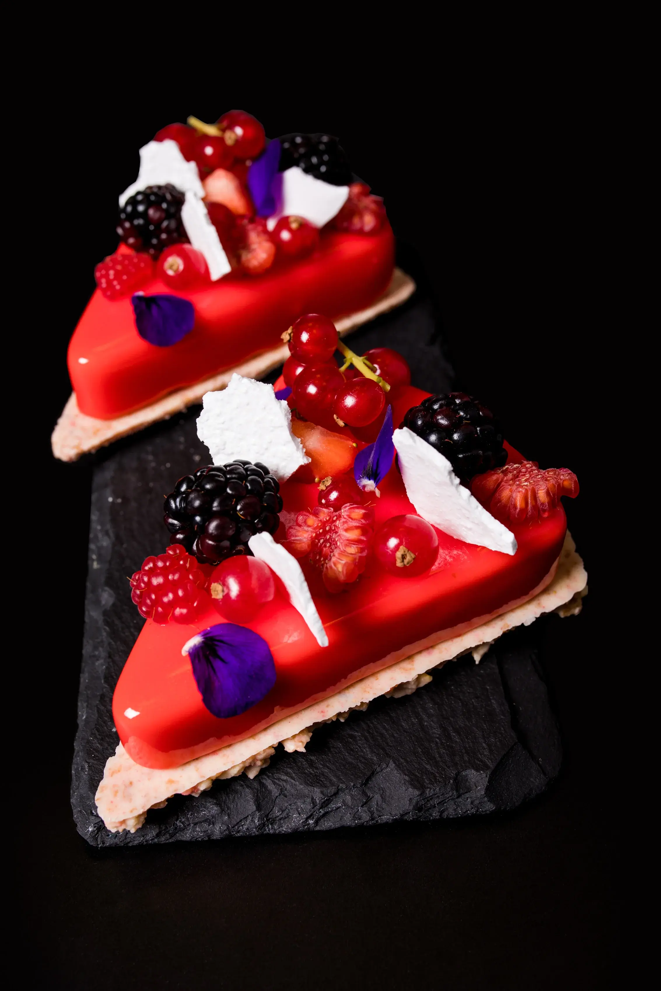 Berry tart with fresh berries and edible flowers